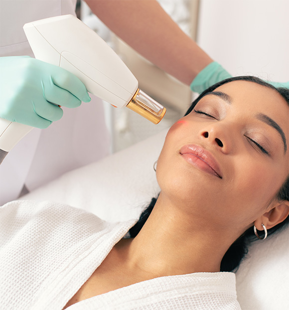 Peaceful woman closing her eyes during the modern laser treatment